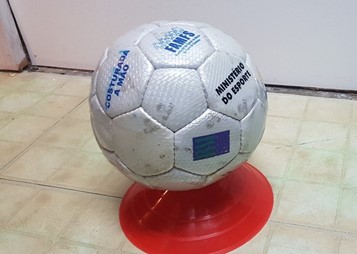 Close up of a soccer ball sitting on top of a cone