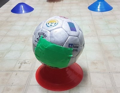 Soccer ball sits on top of a small cone